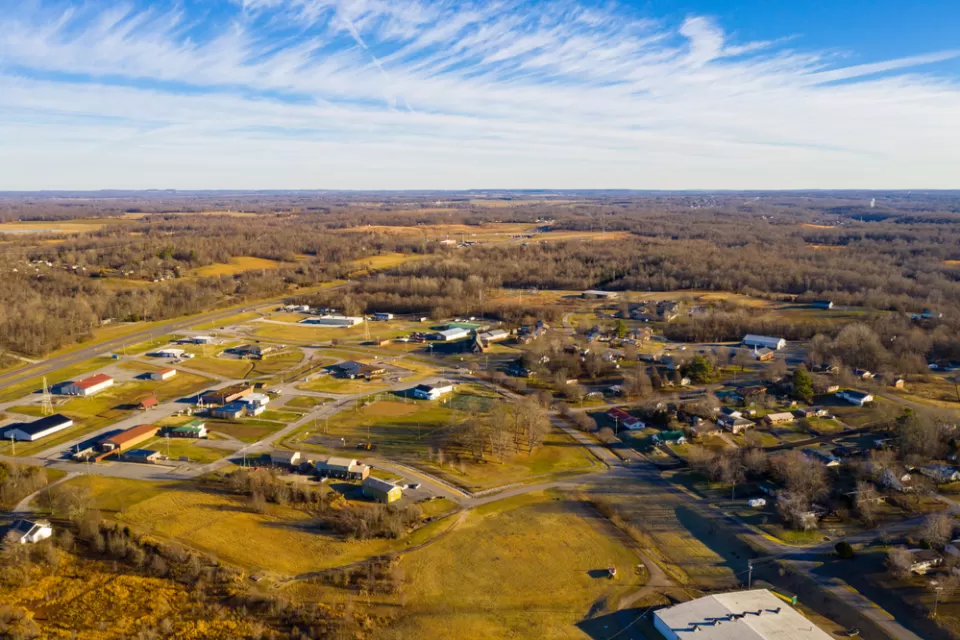 Aerial view of small rural community in Kentucky with ild rolling hills and sparse development